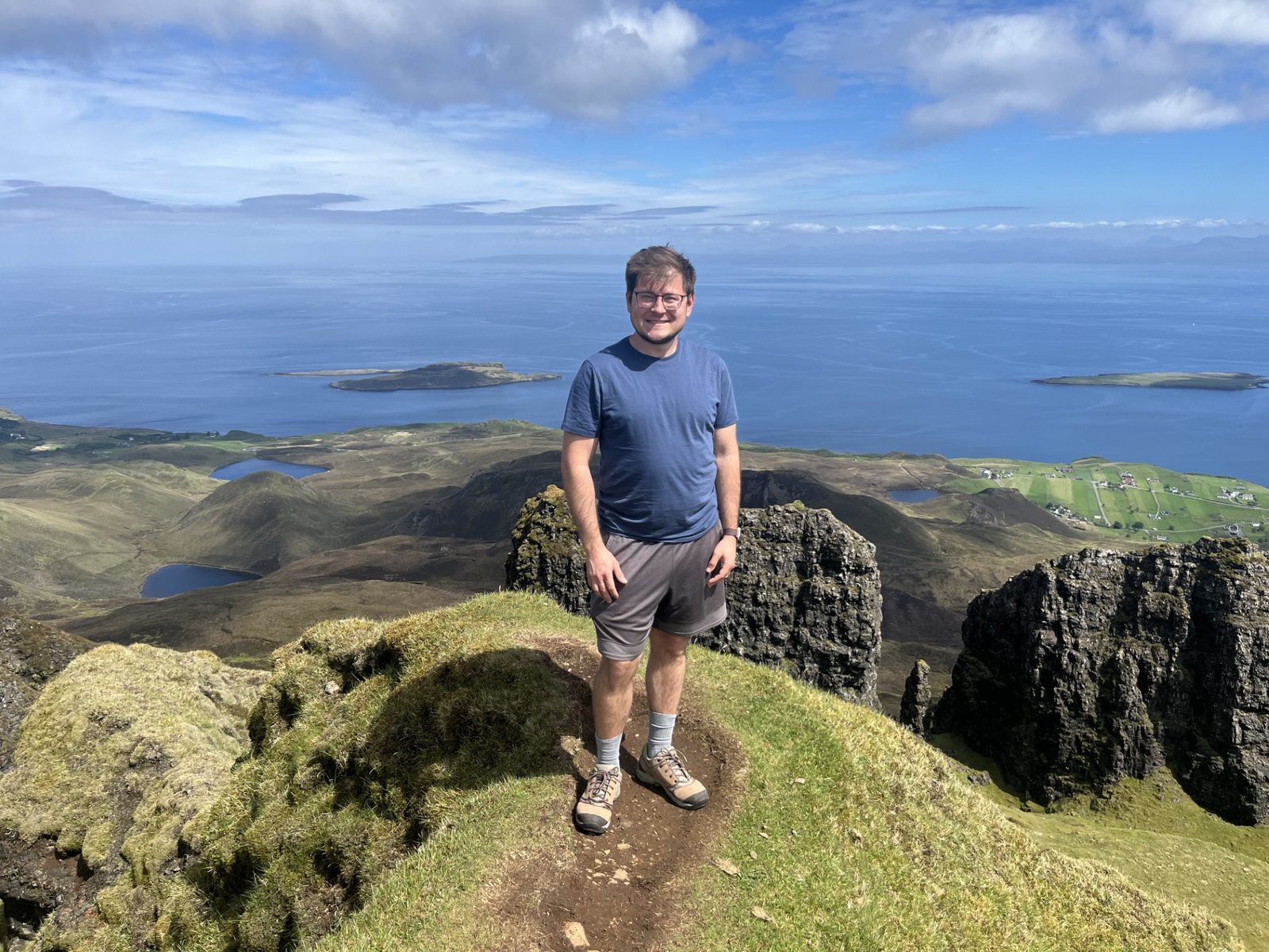Vitaliy Maksymets standing on a mountain trail above the sea